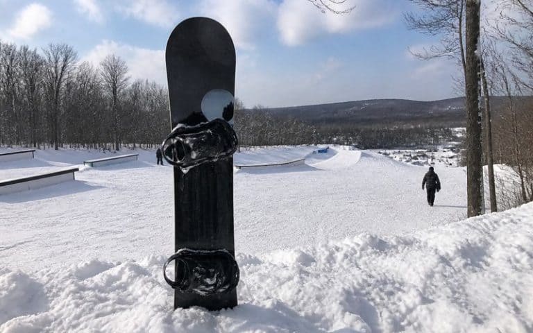 Twin-Tip-Snowboard steht im Schnee